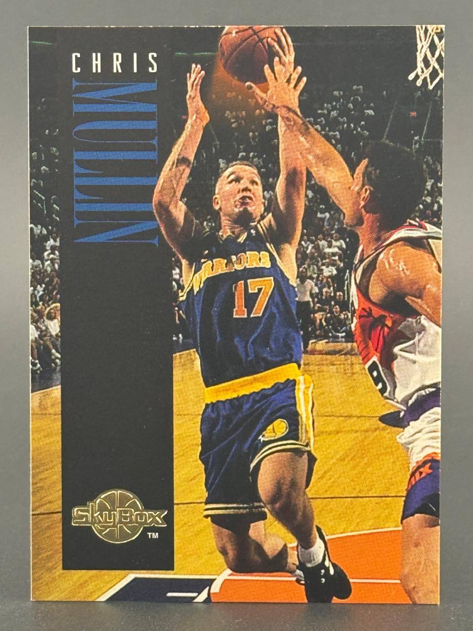 Trading card of Chris Mullin in a blue Warriors 17 jersey shooting a basketball under a SkyBox logo.