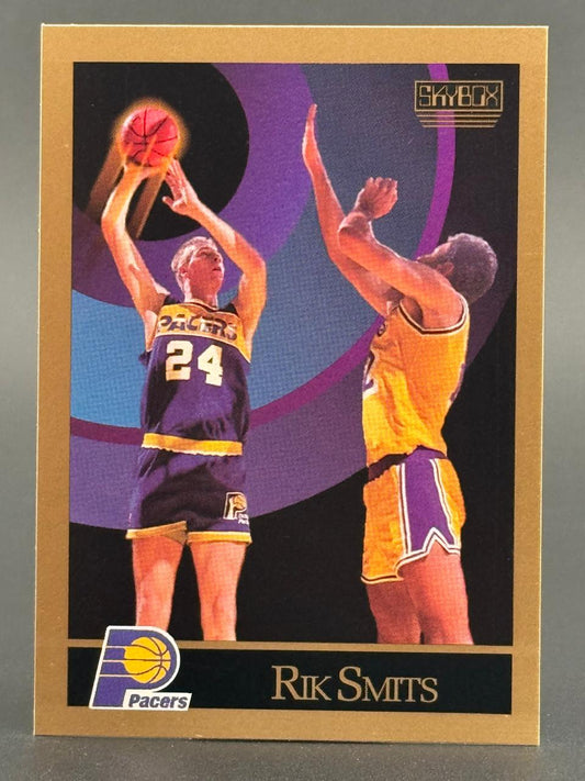 1991 SkyBox Rik Smits Pacers basketball card showing him shooting over a defender.