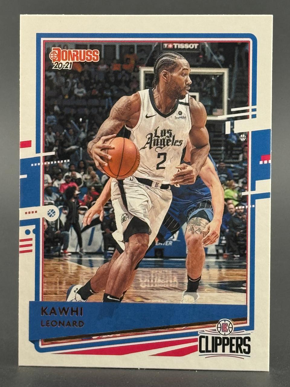 2020-21 Donruss Kawhi Leonard trading card featuring him dribbling in a Los Angeles Clippers uniform.