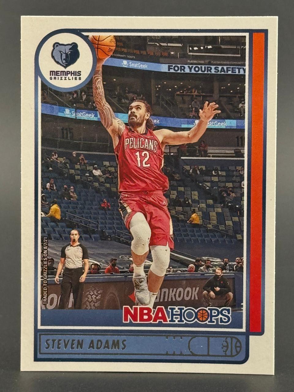 Steven Adams 2021-22 NBA Hoops basketball card featuring him in a Pelicans uniform dunking.