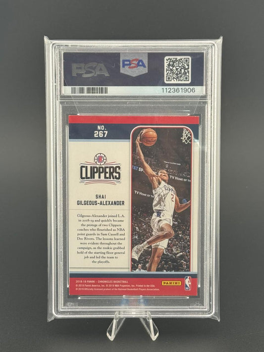 PSA-graded 2018-19 Panini Chronicles basketball card #267 of Shai Gilgeous-Alexander, shown in a vertical dunk.