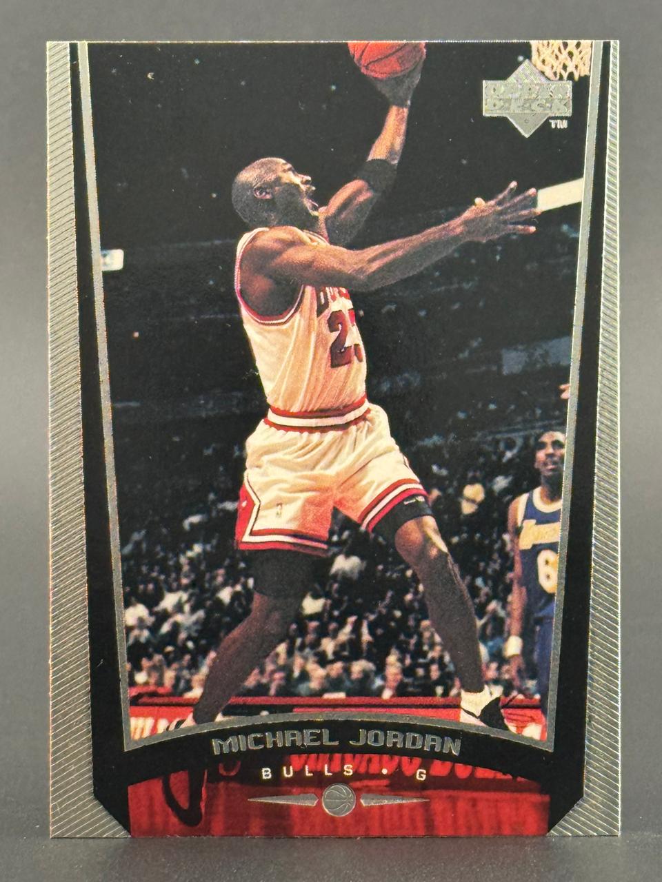 Michael Jordan basketball trading card, Upper Deck brand, featuring Jordan in a Bulls uniform shooting a layup.