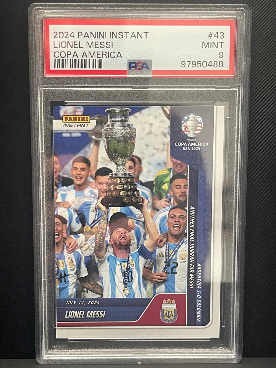 PSA 9 2024 Panini Instant Lionel Messi Copa America #43 card depicting Messi lifting trophy.